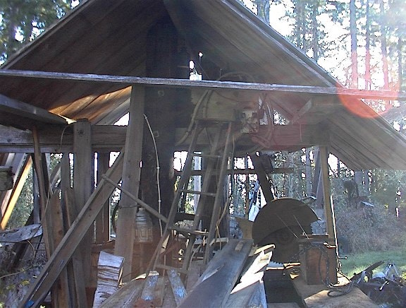 Interior of old wooden shed with tools and lumber