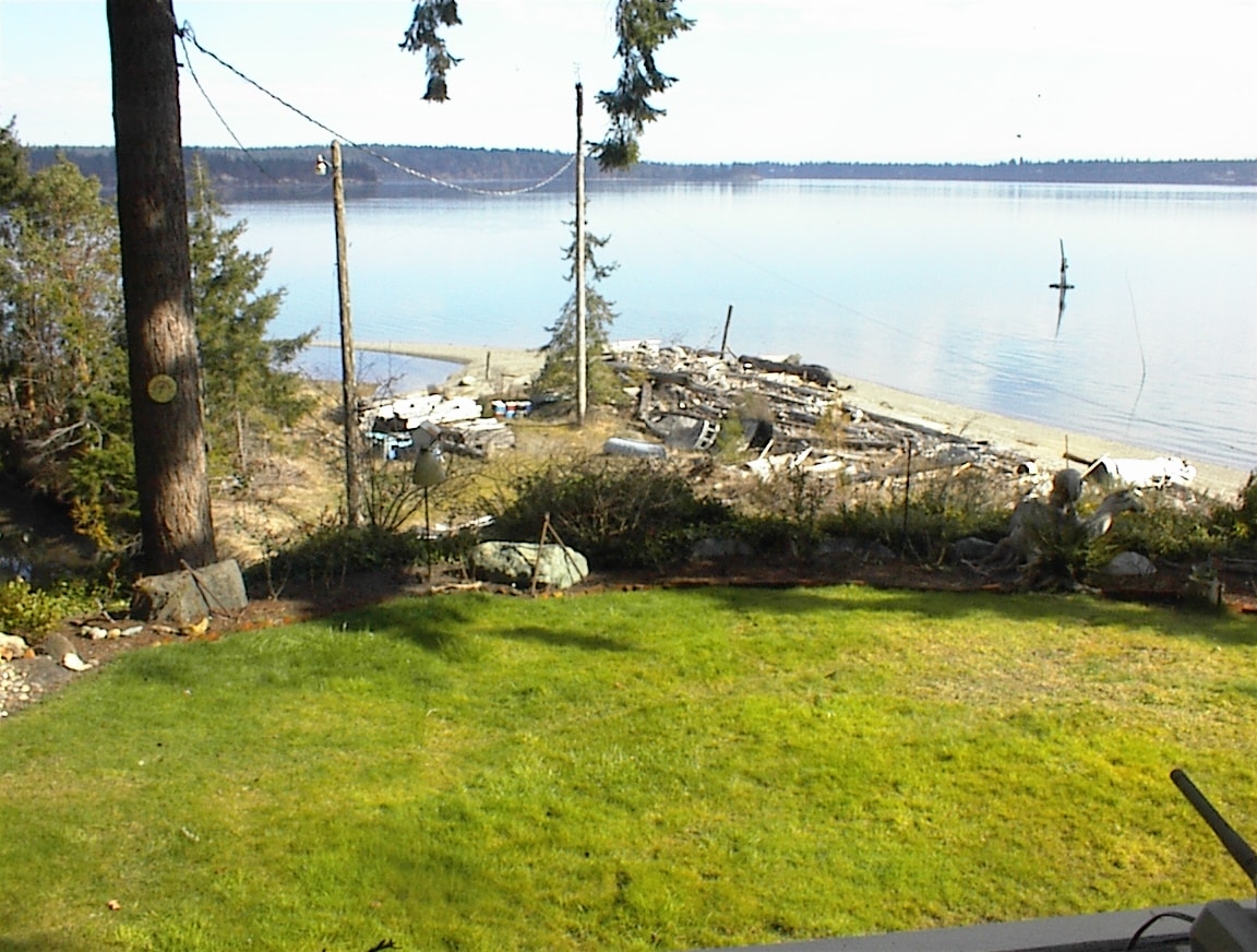 Sunny view of the beach and bay with boathouse remains