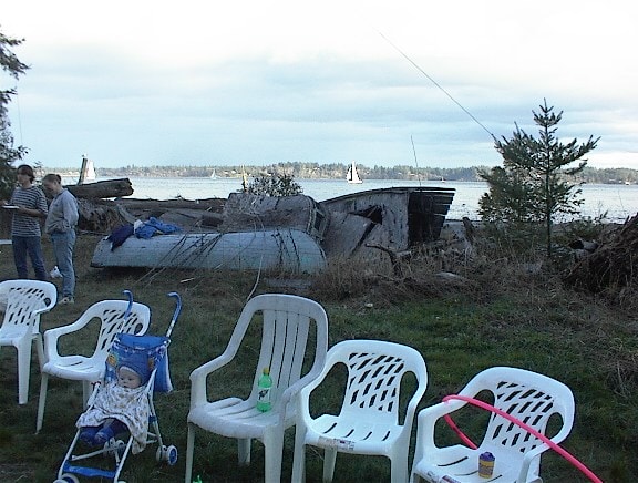 Waterfront scene with chairs and remnants of the boathouse